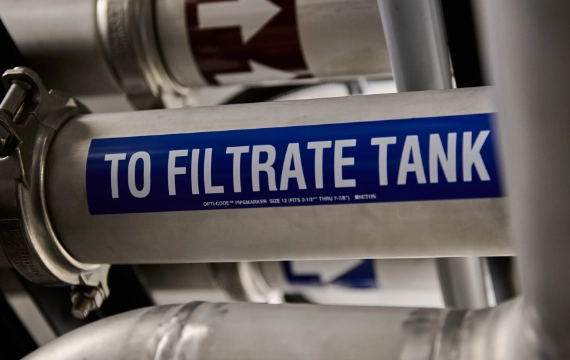 Pipe labeled to filtrate tank inside a containerized water treatment system